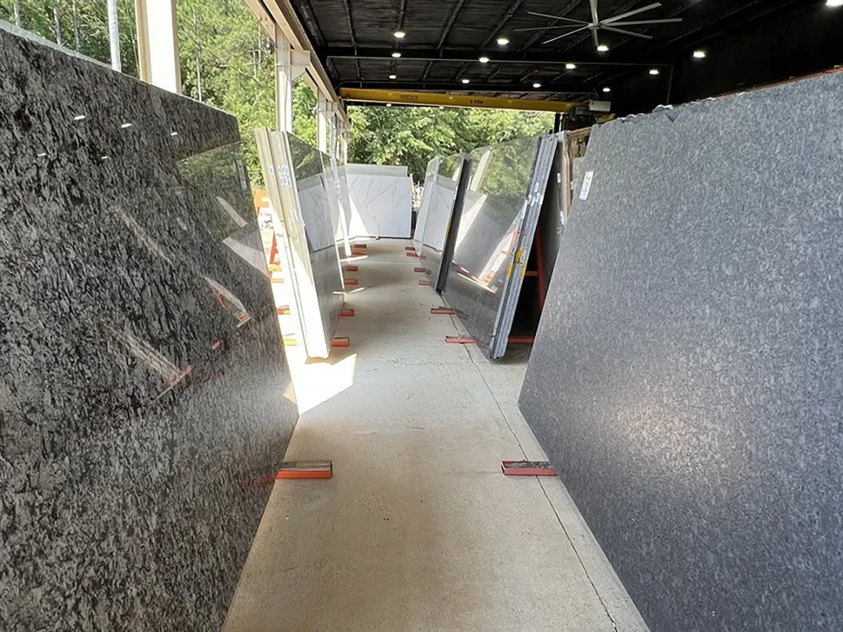 Selection of natural granite slabs displayed side by side in a showroom | Carpetland USA Granite & Flooring