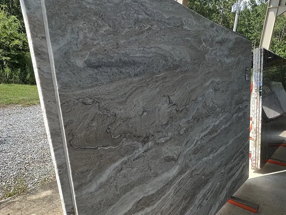 Gray granite slab with natural flowing patterns on display | Carpetland USA Granite & Flooring
