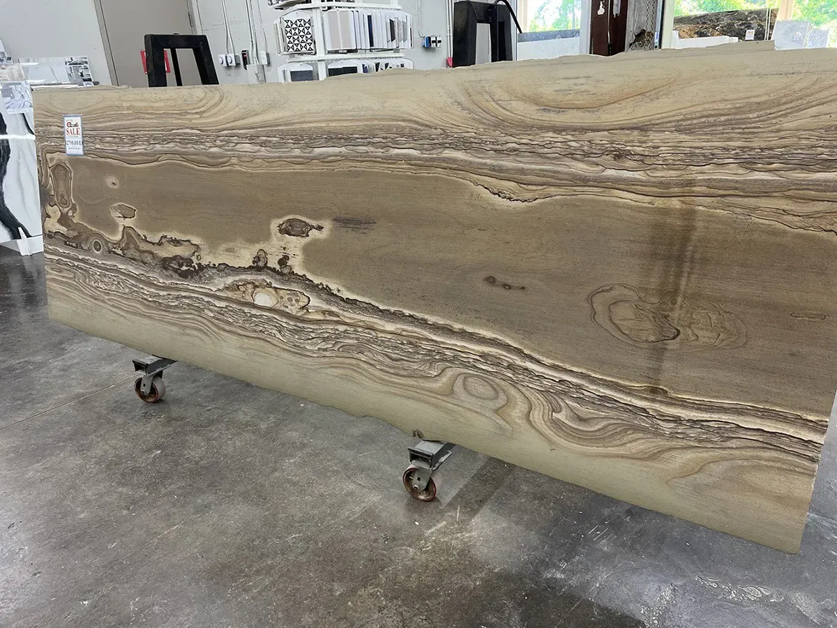 Natural stone slab with layered beige and brown veining on display | Carpetland USA Granite & Flooring