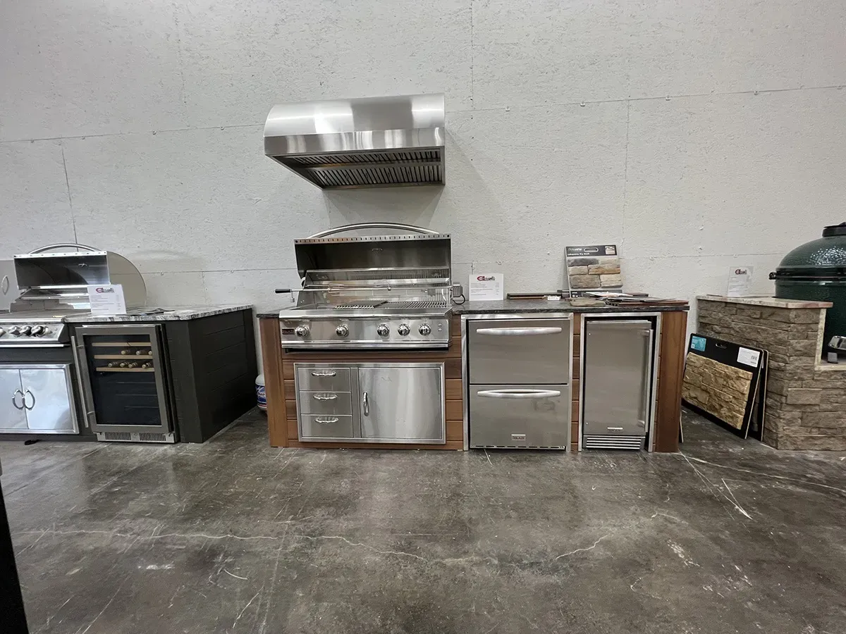 Outdoor grills, refrigerators, and kitchen appliances displayed in a showroom | Carpetland USA Granite & Flooring