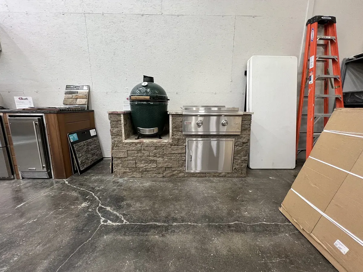 Outdoor cooking appliances and grill setup displayed at a showroom | Carpetland USA Granite & Flooring