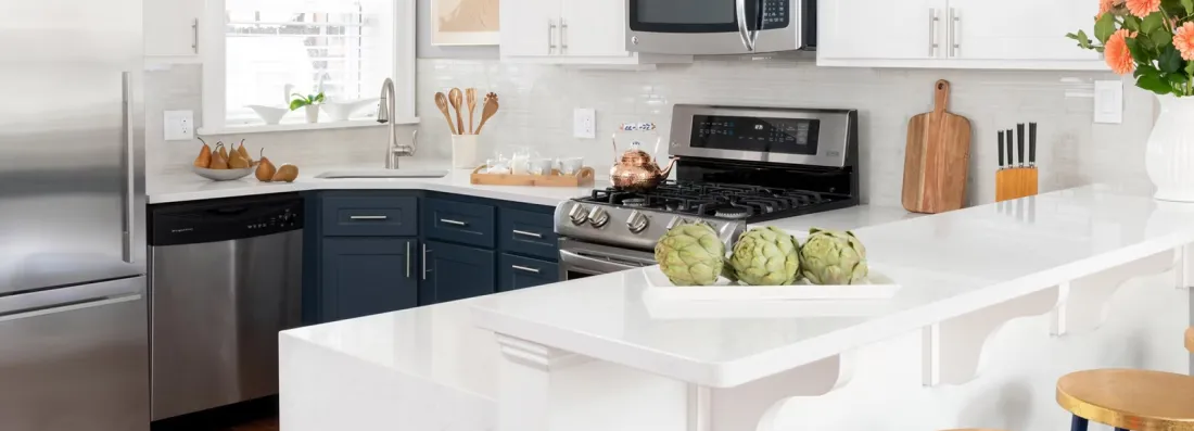 Close up of kitchen countertop with bar height seating | Carpetland USA Granite & Flooring