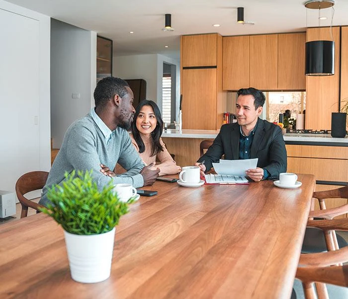 Couple reviewing flooring financing documents with a representative | Carpetland USA Granite & Flooring