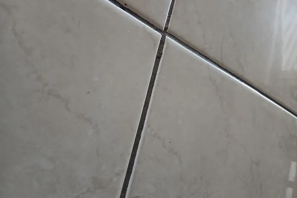 Grout grime buildup between tile flooring | Carpetland USA Granite & Flooring
