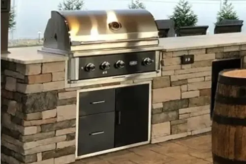 Marine grade grill in outside kitchen with water view | Carpetland USA Granite & Flooring