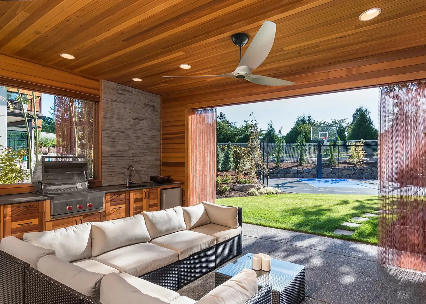 Modern outdoor kitchen with grill, sink fan and sitting area | Carpetland USA Granite & Flooring