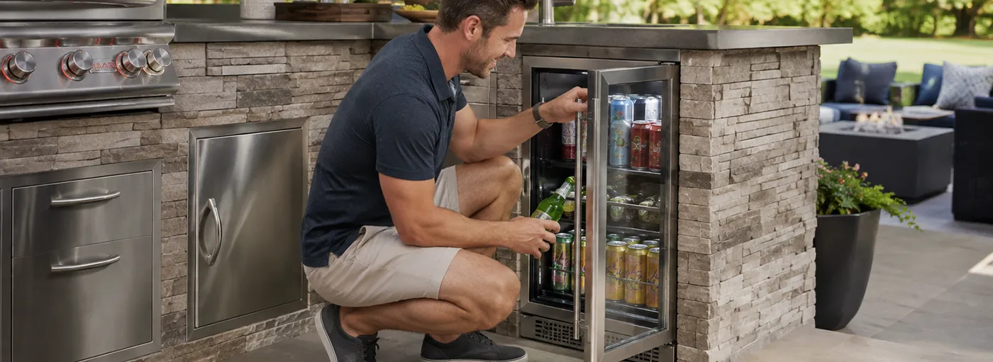 Man getting a drink out of an outdoor refrigerator | Carpetland USA Granite & Flooring