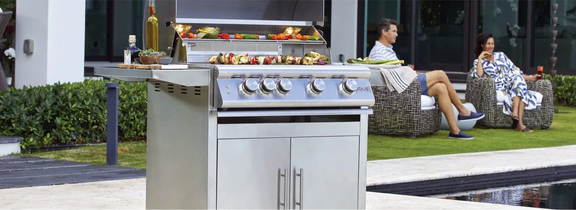 blaze Outdoor-Grill gathering with friend | Carpetland USA Granite & Flooring